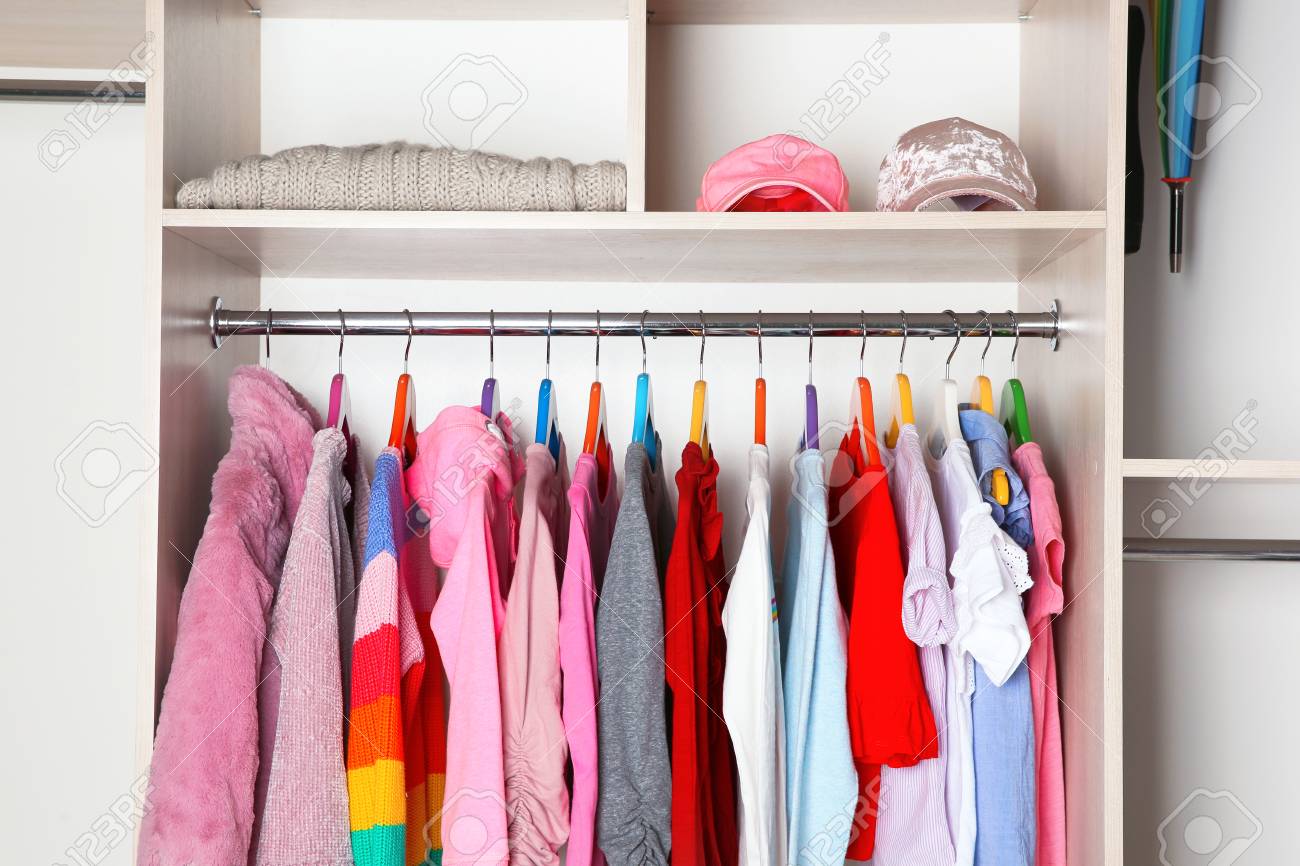 Wardrobe With Stylish Girl S Clothes Hanging On Rack Stock Photo