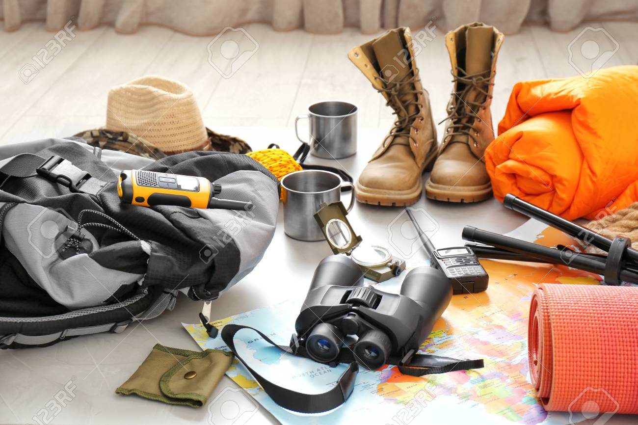 Set Of Camping Equipment With Sleeping Bag On Floor Stock Photo