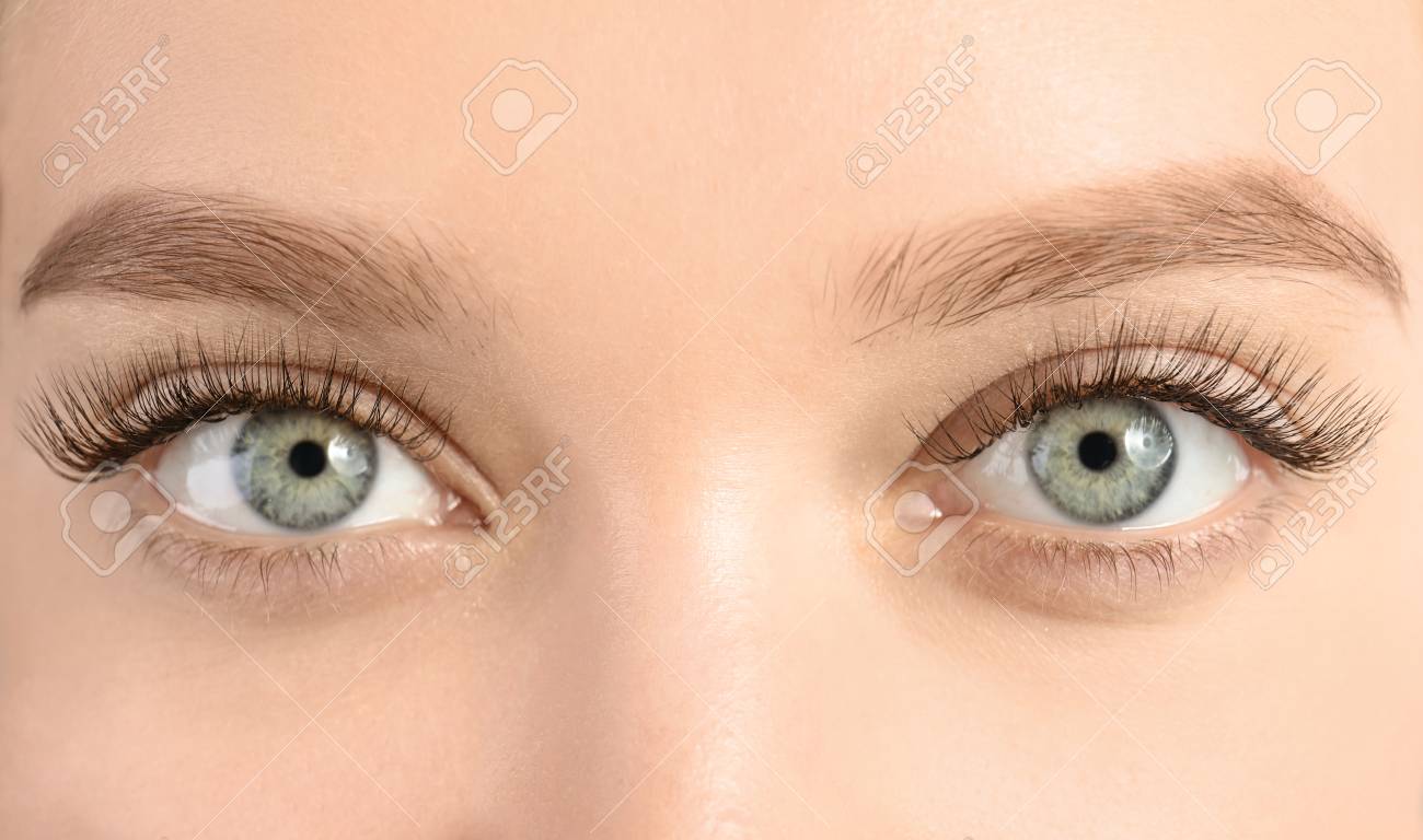 Young woman with beautiful long eyelashes, closeup. Extension procedure - 113446266 Young woman with beautiful long eyelashes, closeup. Extension procedure - 113446266