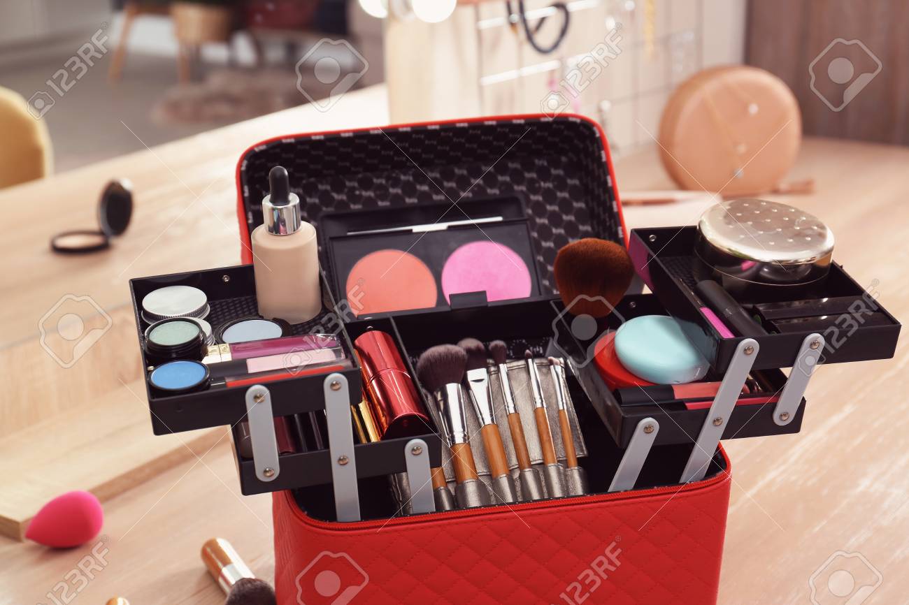 Beautician case with professional makeup products and tools on..