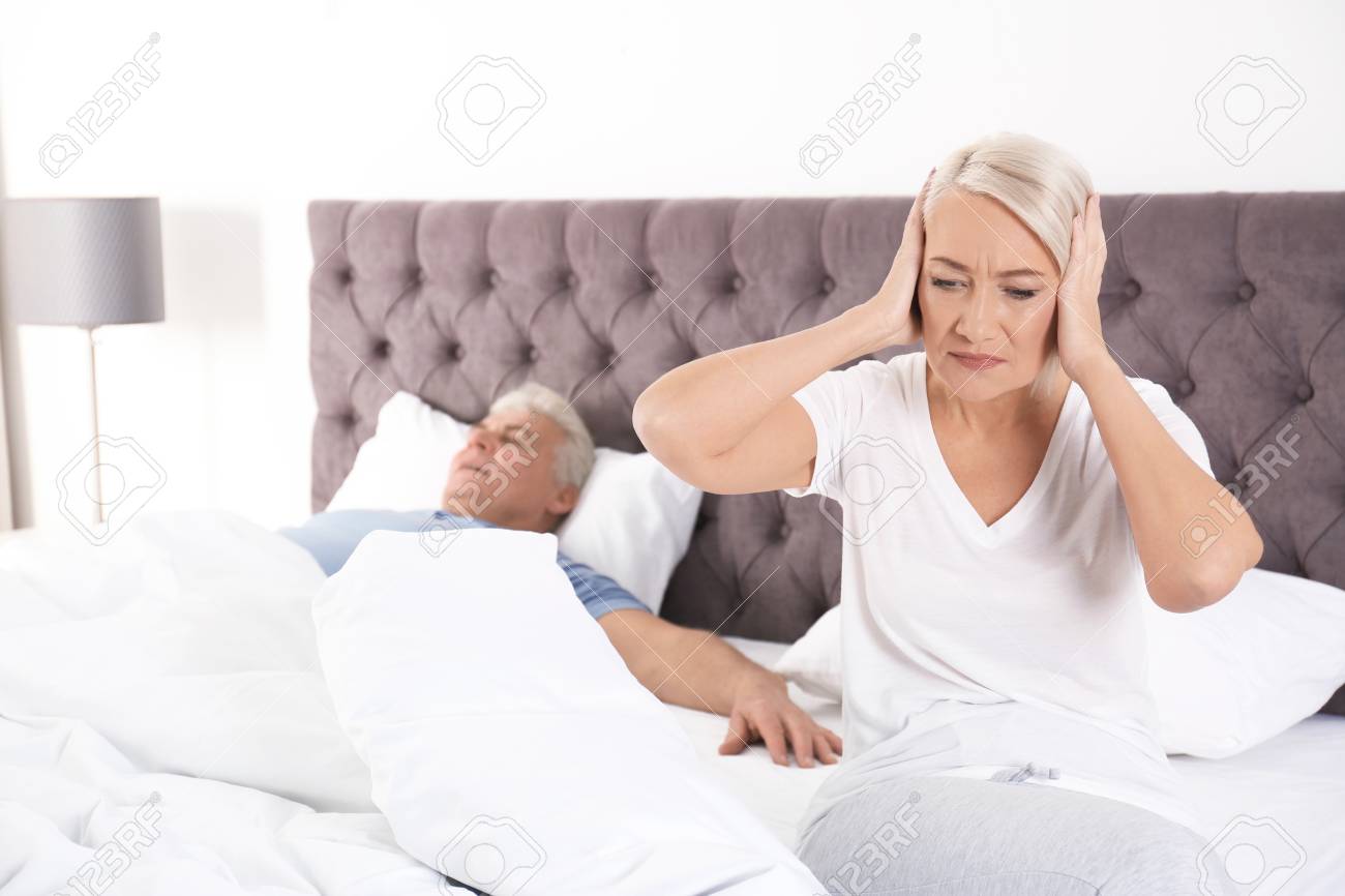 Upset Mature Woman Sitting On Bed Near image