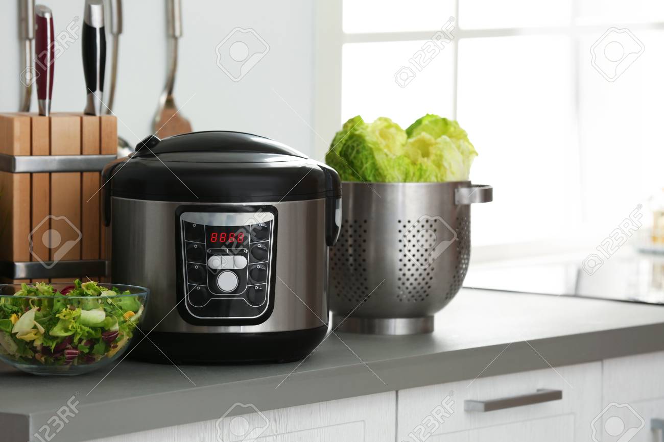 Modern electric multi cooker and food on kitchen countertop. Space for text - 116359105 Modern electric multi cooker and food on kitchen countertop. Space for text - 116359105