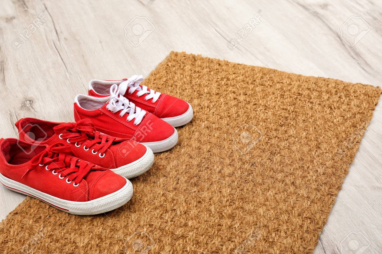 New Clean Doormat With Shoes On Floor Space For Text