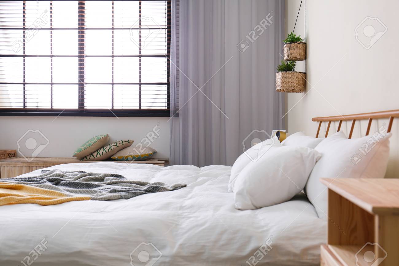 Modern Room Interior With Comfortable Double Bed And Window Blinds