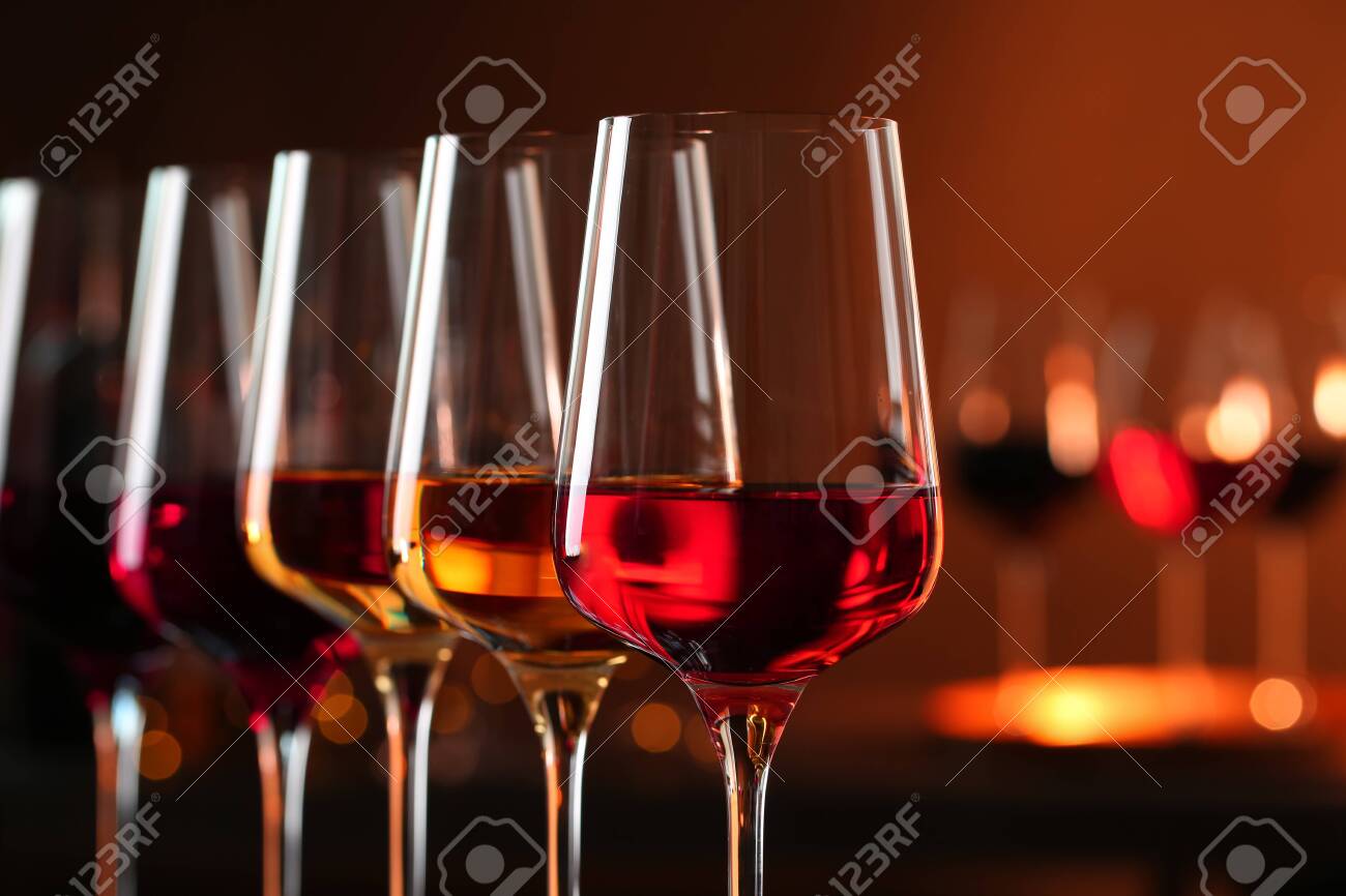 Row of glasses with different wines against blurred background, closeup. Space for text - 122530365 Row of glasses with different wines against blurred background, closeup. Space for text - 122530365