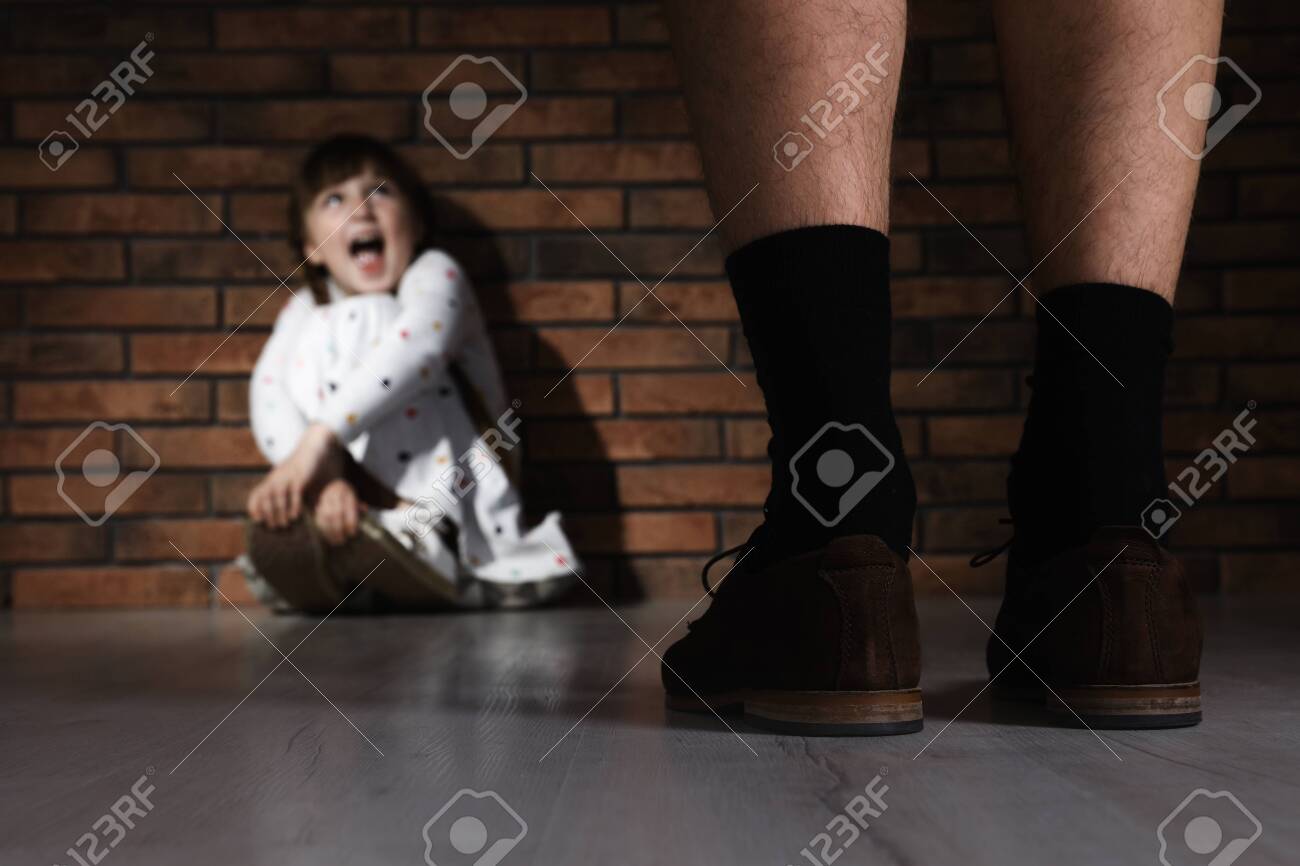 Adult man without pants standing in front of scared little girl indoors. Child in danger - 126788184 Adult man without pants standing in front of scared little girl indoors. Child in danger - 126788184