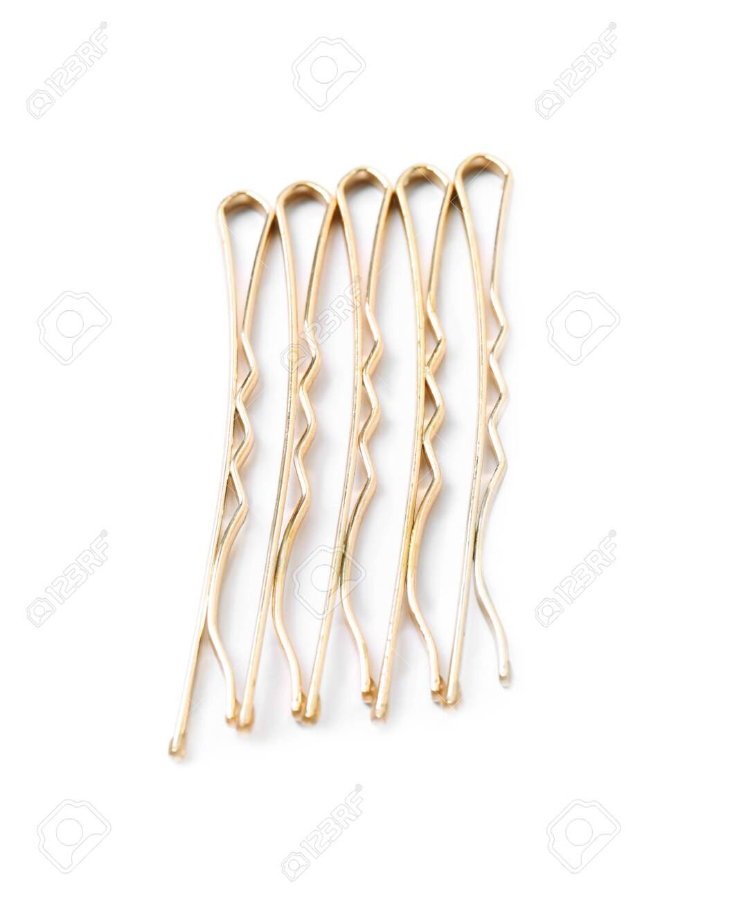 Many Gold Hair Pins On White Background Top View
