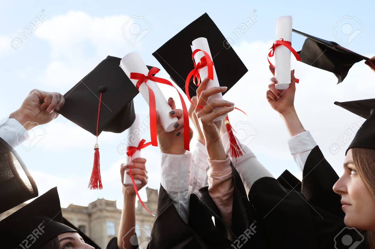 Group of students with diplomas outdoors. Graduation ceremony - 133347889 Group of students with diplomas outdoors. Graduation ceremony - 133347889