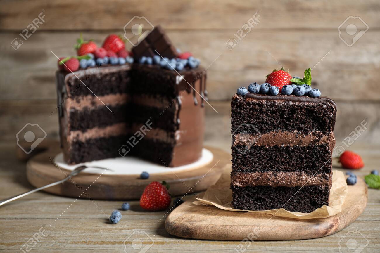 Delicious chocolate cake decorated with fresh berries on wooden table - 133309232 Delicious chocolate cake decorated with fresh berries on wooden table - 133309232