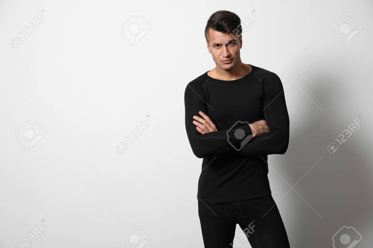 Man wearing thermal underwear on light grey background. Space for text - 135323755 Man wearing thermal underwear on light grey background. Space for text - 135323755