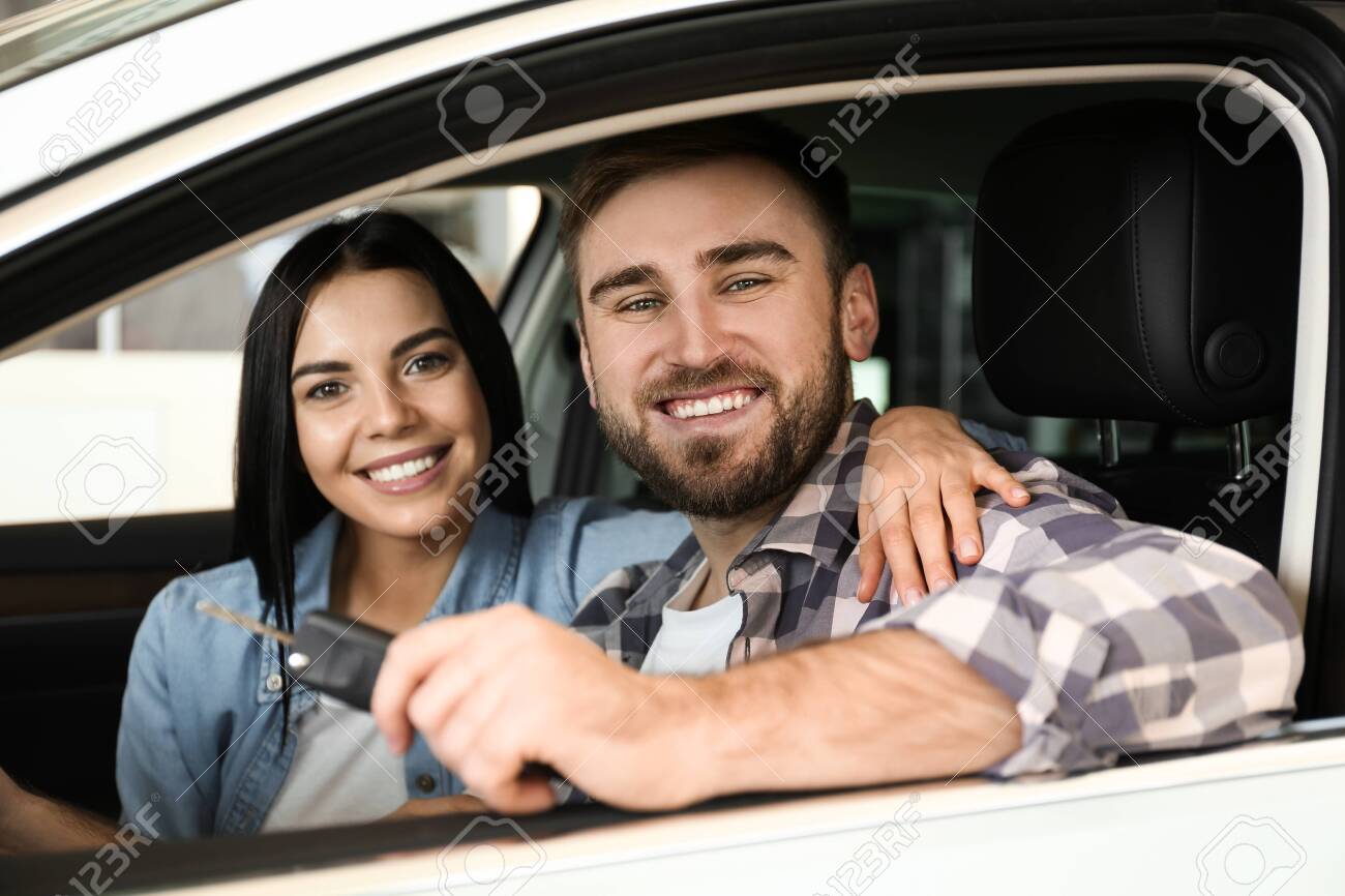 Happy couple with car key sitting in modern auto at dealership - 139494211 Happy couple with car key sitting in modern auto at dealership - 139494211