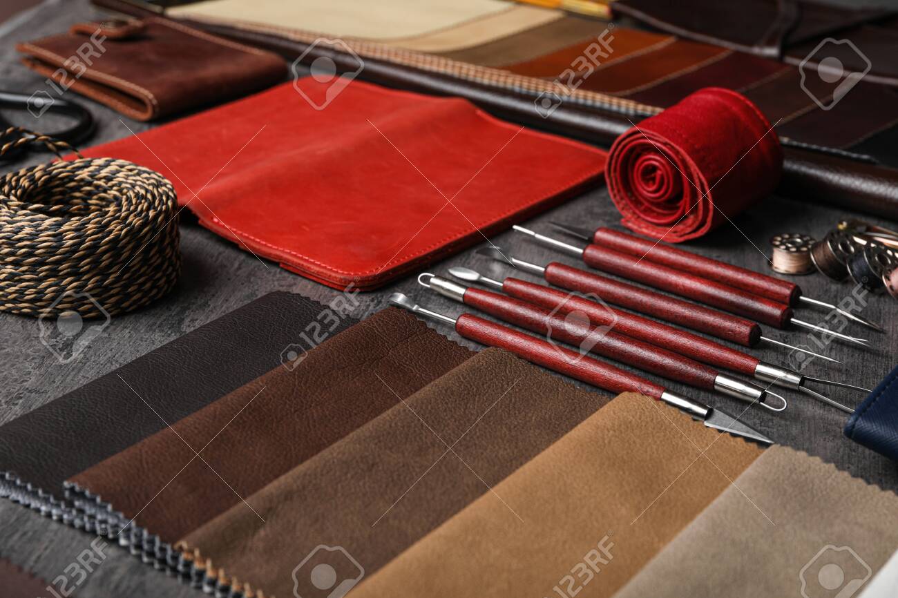 Leather samples and craftsman tools on grey stone background - 141372113 Leather samples and craftsman tools on grey stone background - 141372113