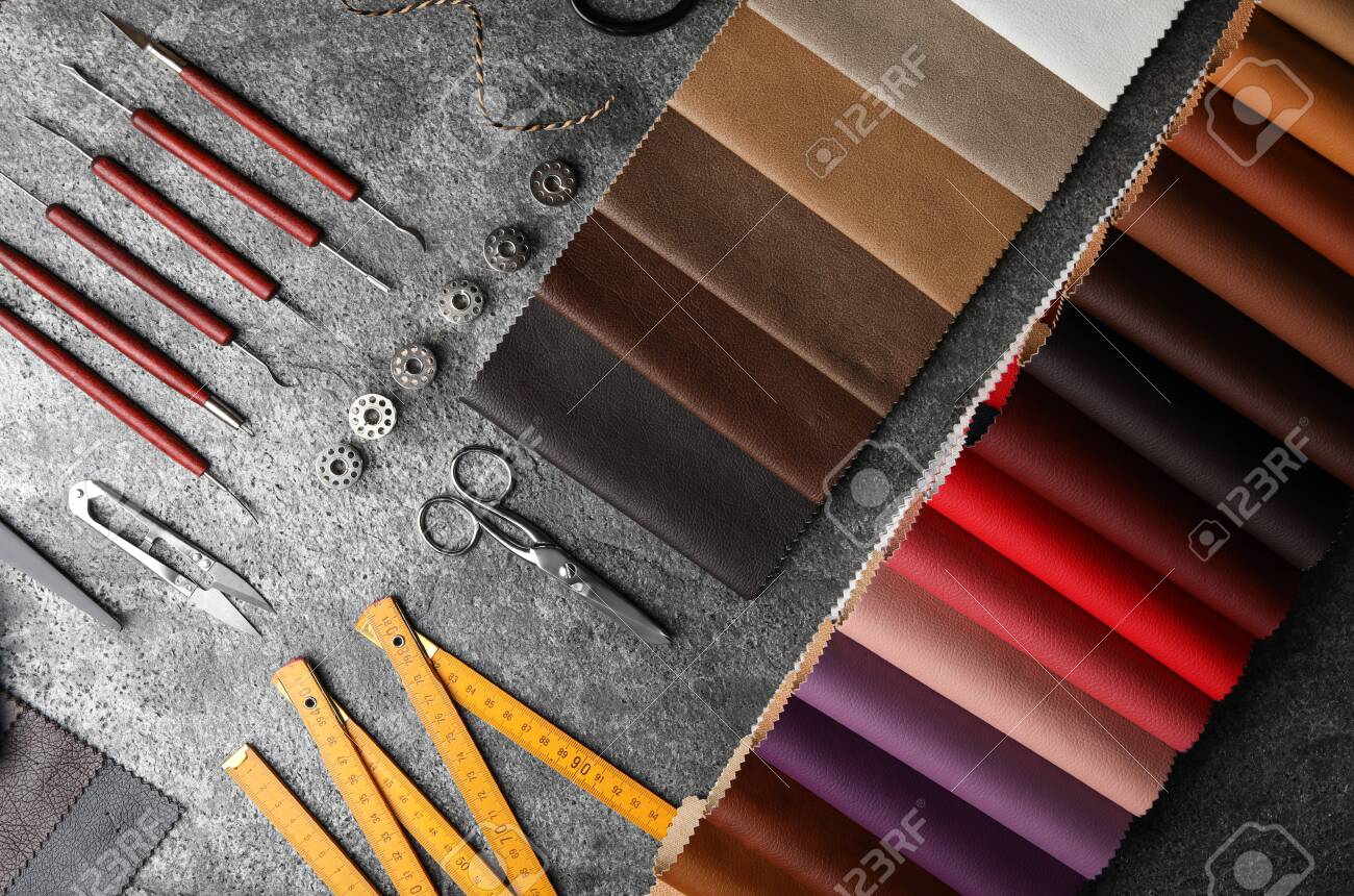 Flat lay composition with leather samples and craftsman tools on grey stone background - 141377434 Flat lay composition with leather samples and craftsman tools on grey stone background - 141377434