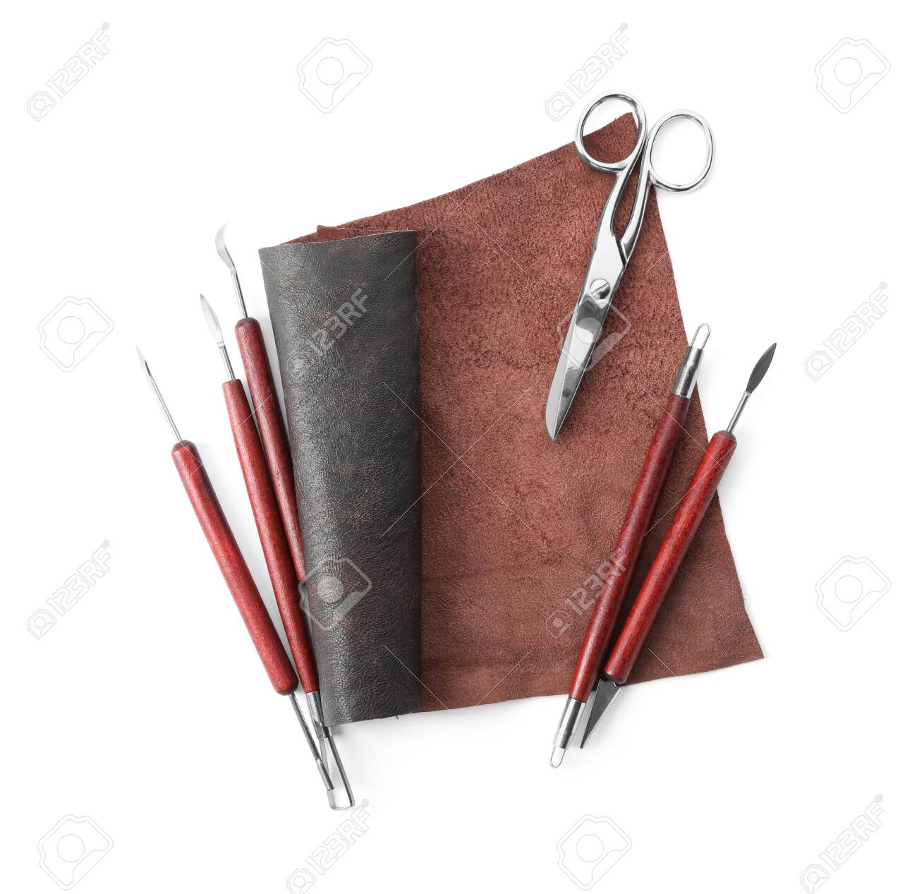 Leather sample and craftsman tools isolated on white, top view - 141534000 Leather sample and craftsman tools isolated on white, top view - 141534000
