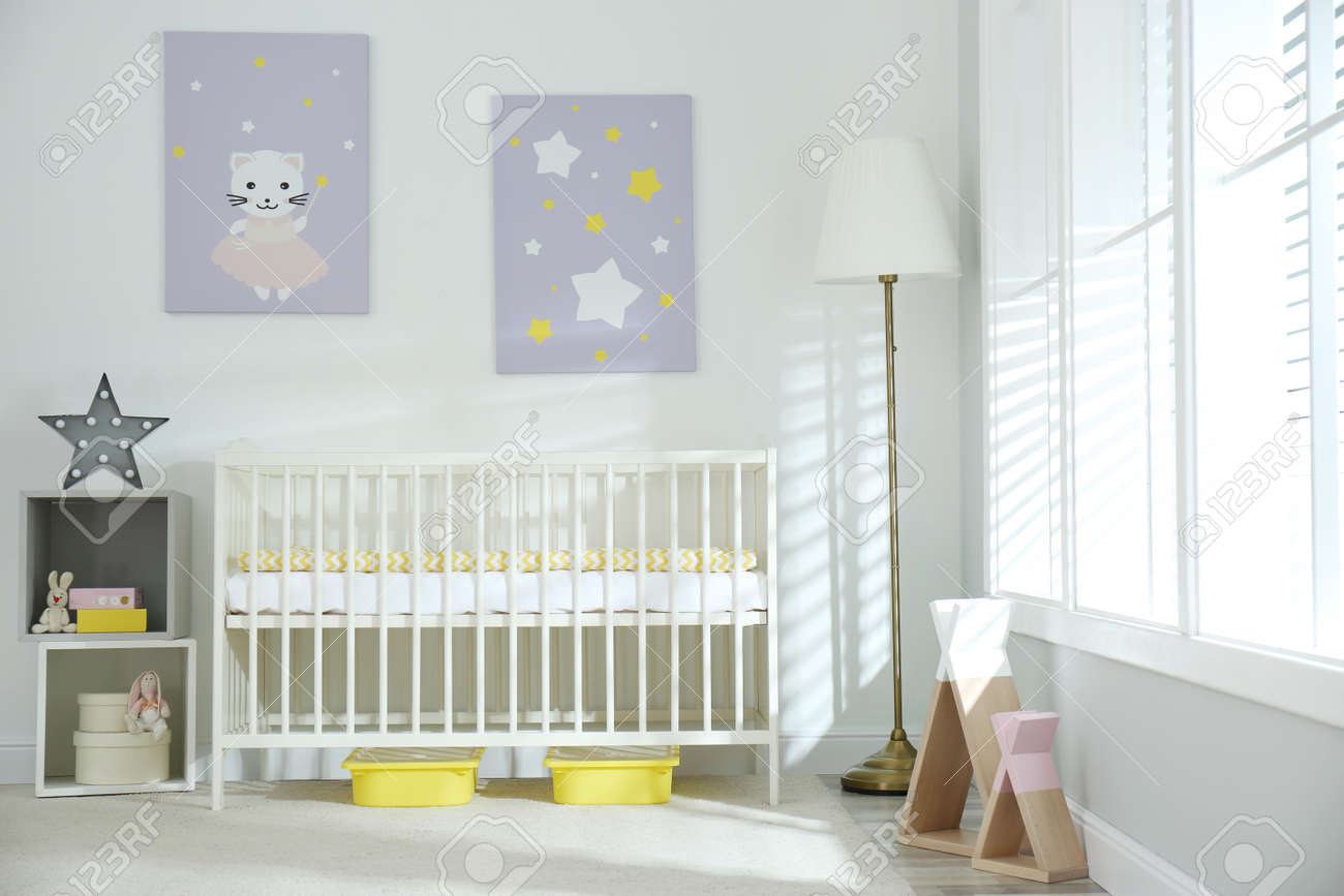 Stylish baby room interior with crib and cute pictures on wall - 155500109 Stylish baby room interior with crib and cute pictures on wall - 155500109
