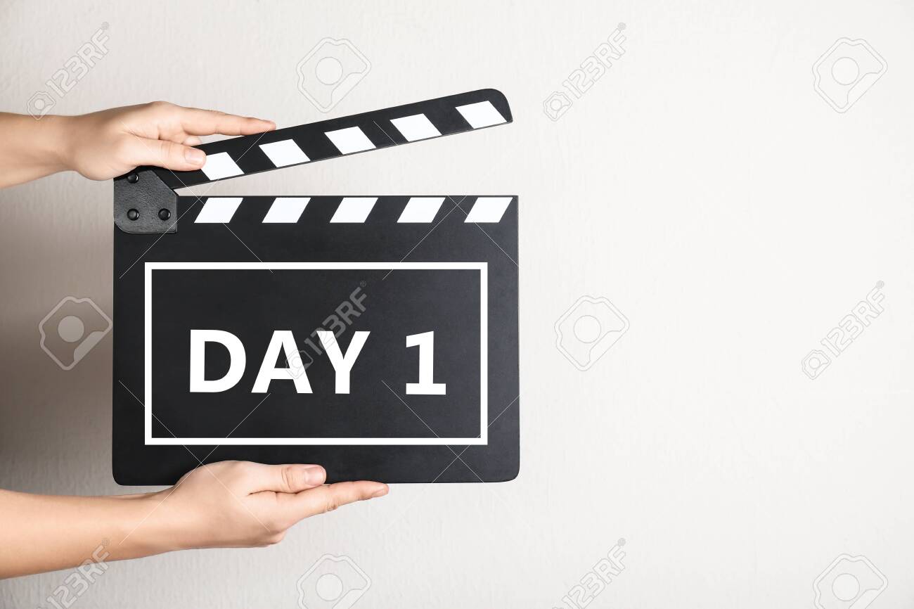 Starting new life chapter. Woman holding clapperboard with text Day 1, closeup - 154492807 Starting new life chapter. Woman holding clapperboard with text Day 1, closeup - 154492807