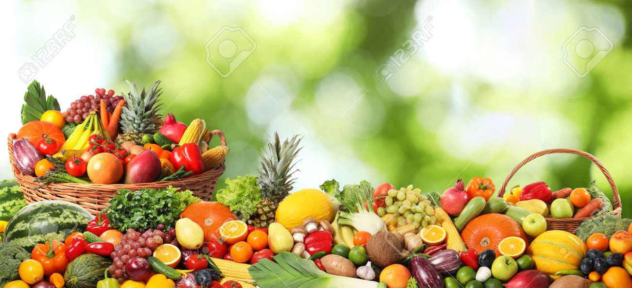 Assortment of fresh organic vegetables and fruits on blurred green background - 158619542 Assortment of fresh organic vegetables and fruits on blurred green background - 158619542