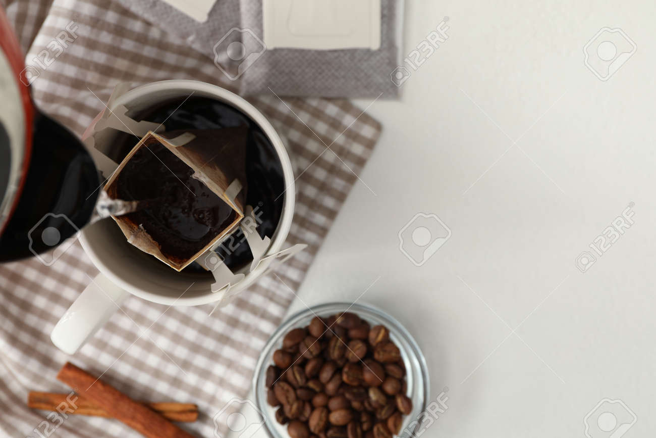 Download Pouring Hot Water Into Cup With Drip Coffee Bag On White Table Stock Photo Picture And Royalty Free Image Image 159108202