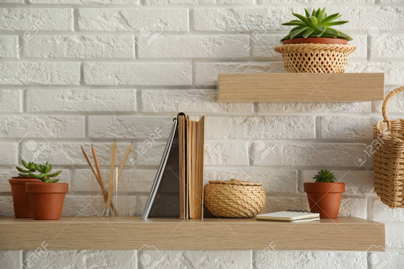 Shelves With Decorative Elements On White Brick Wall Interior Stock Photo Picture And Royalty Free Image Image 161077258