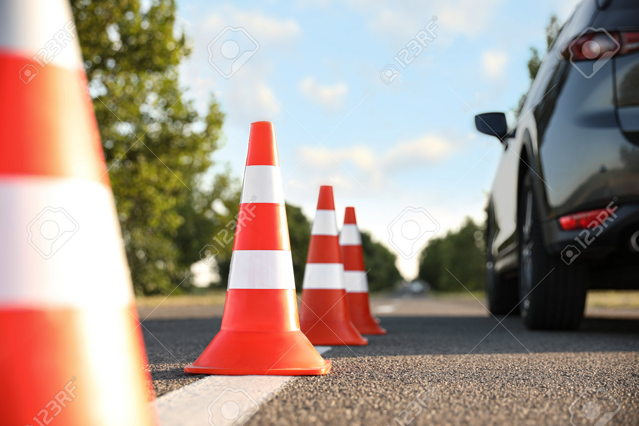 Traffic cones near car outdoors. Driving school exam - 162000540 Traffic cones near car outdoors. Driving school exam - 162000540