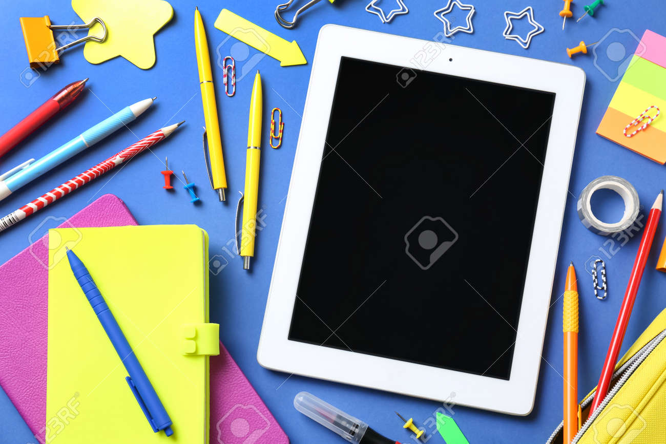 Flat lay composition with tablet on blue background - 165589596 Flat lay composition with tablet on blue background - 165589596