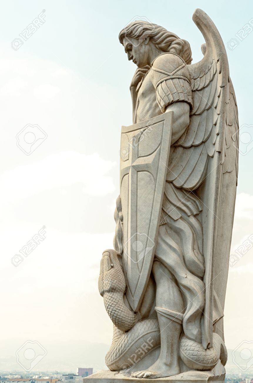 statue of the archangel michael stands on top of tepeyac hill