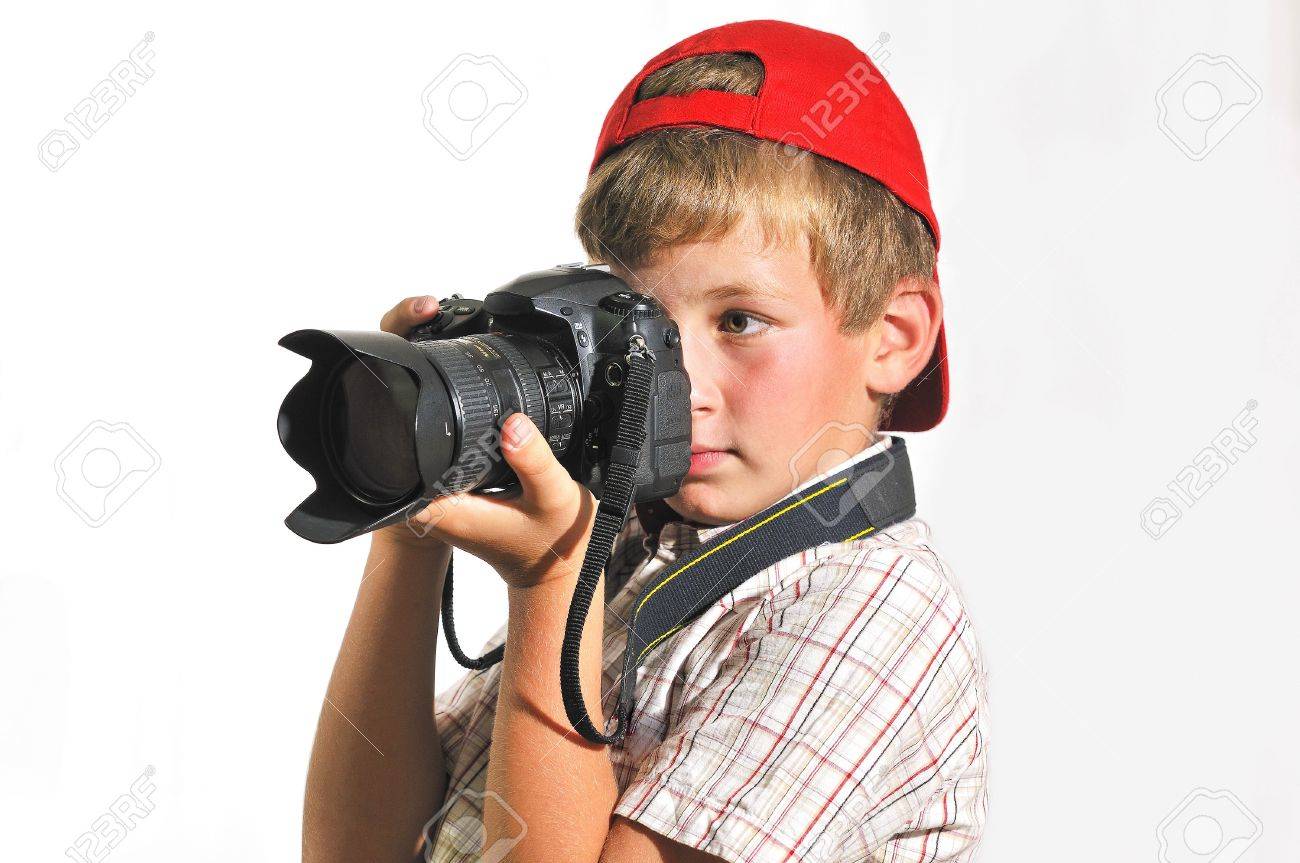 boy holding a camera and someone photographs stock photo picture