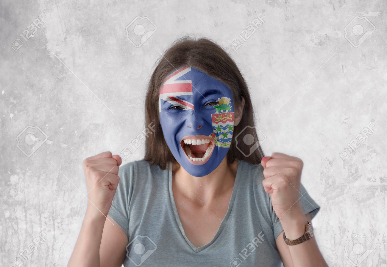 Young Woman With Painted Flag Of Cayman Island And Open Mouth Looking  Energetic With Fists Up Stock Photo, Picture and Royalty Free Image. Image  182169485., image size:1300x896