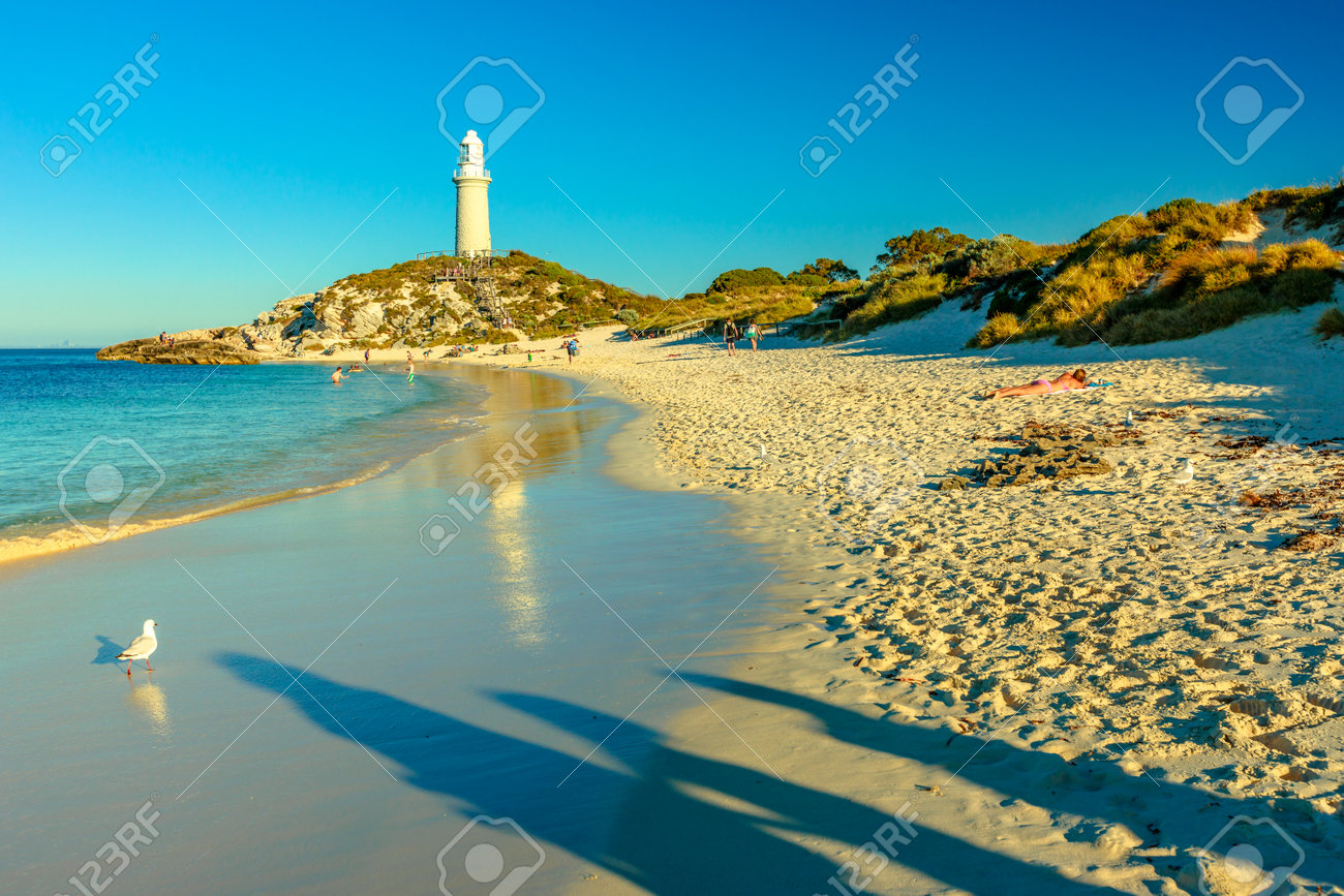 Rottnest Island, Western Australia - Jan 4, 2018: People On Pinky Beach And  Bathurst Lighthouse Reflecting On Turquoise Sea In Late Afternoon. North  Coast Of Rottnest Island, Perth, Western Australia. Stock Photo,, image size:1300x867