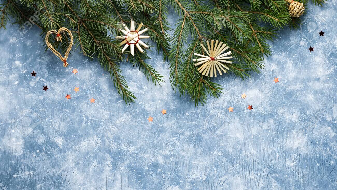 Christmas card with fir tree branches, red ribbons and decorations, wooden ornaments, confetti. Copy space, top view - 129197317 Christmas card with fir tree branches, red ribbons and decorations, wooden ornaments, confetti. Copy space, top view - 129197317