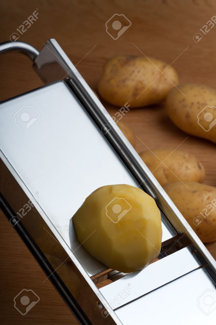 Half A Potato On A Mandolin Slicer Stock Photo Half A Potato On A Mandolin Slicer Stock Photo