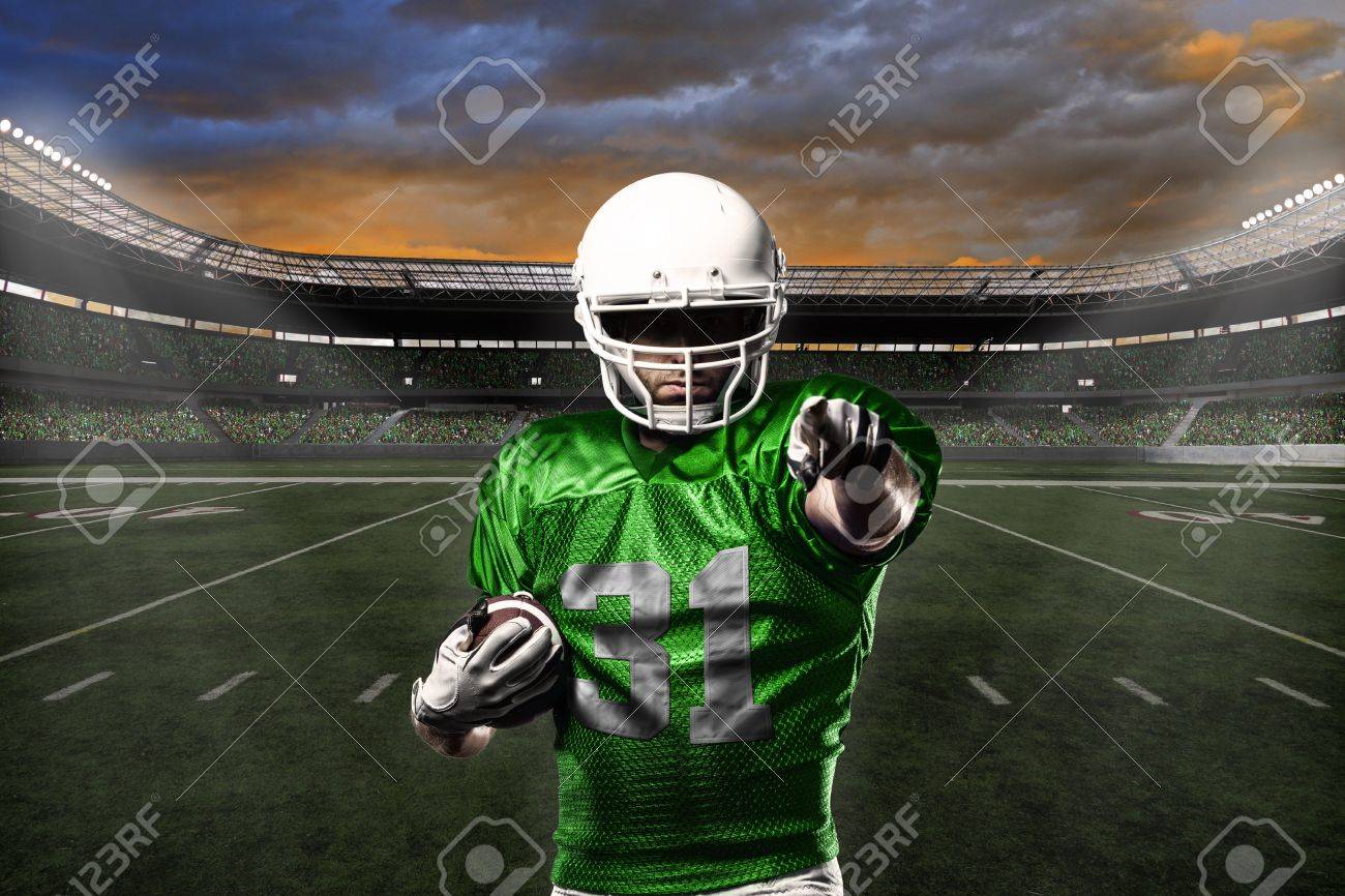 Football Player with a green uniform celebrating with the fans. - 21782203 Football Player with a green uniform celebrating with the fans. - 21782203