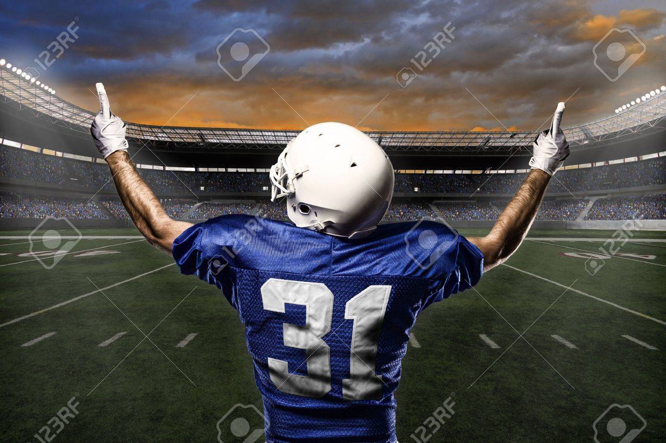 Football Player with a blue uniform celebrating with the fans. - 21782208 Football Player with a blue uniform celebrating with the fans. - 21782208