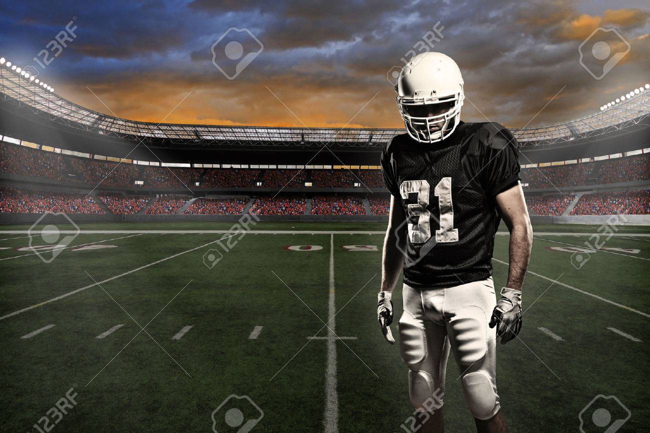 Football player with a black uniform, in a stadium. - 24750184 Football player with a black uniform, in a stadium. - 24750184