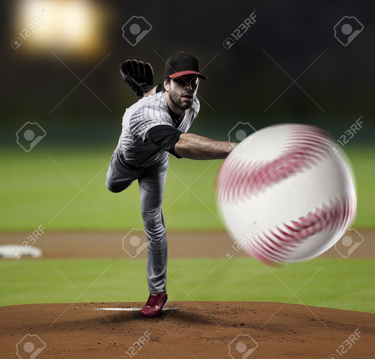 Pitcher Player throwing a ball, on a baseball Stadium. - 27529280 Pitcher Player throwing a ball, on a baseball Stadium. - 27529280
