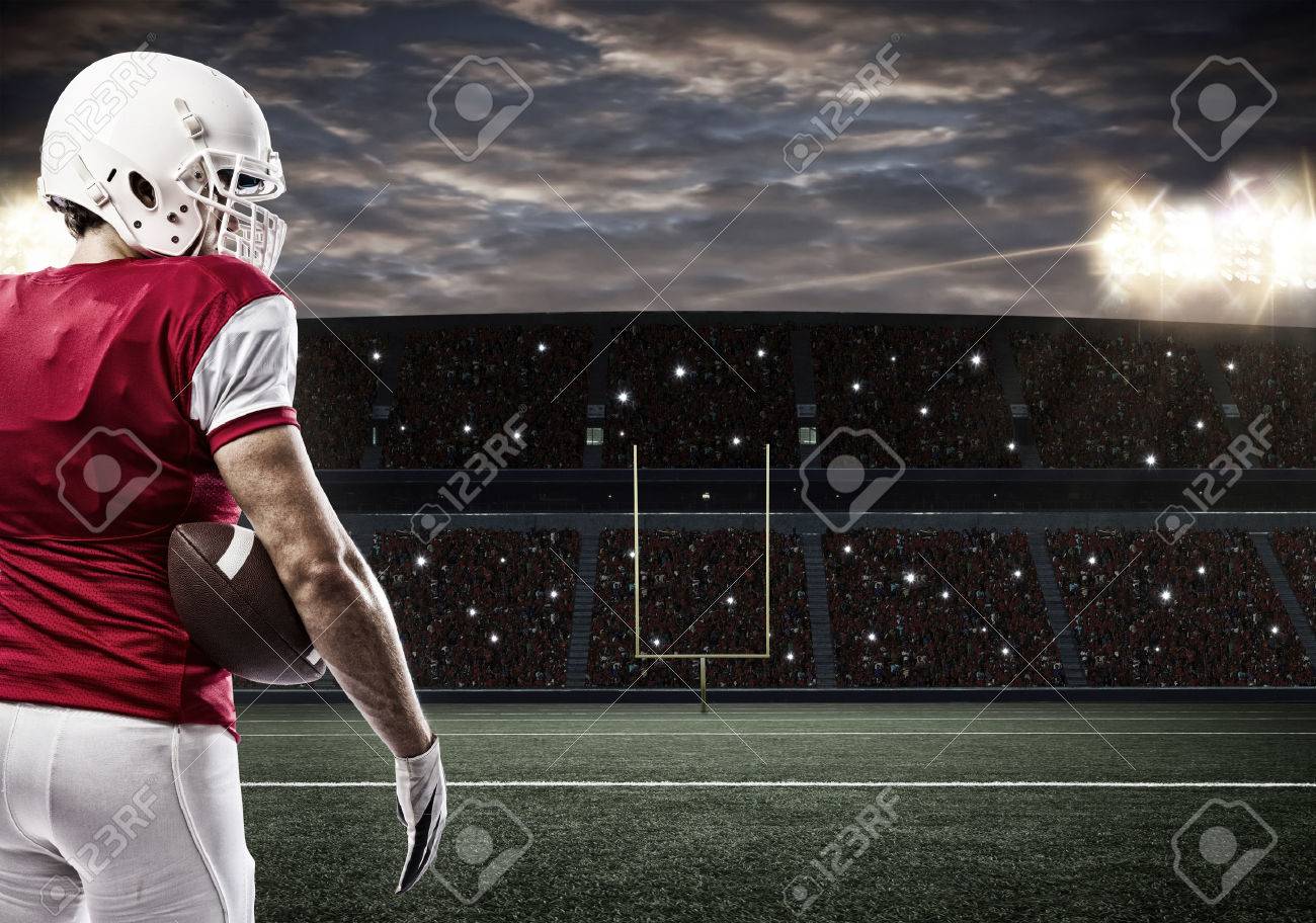 Football Player with a red uniform on a stadium. - 35219293 Football Player with a red uniform on a stadium. - 35219293