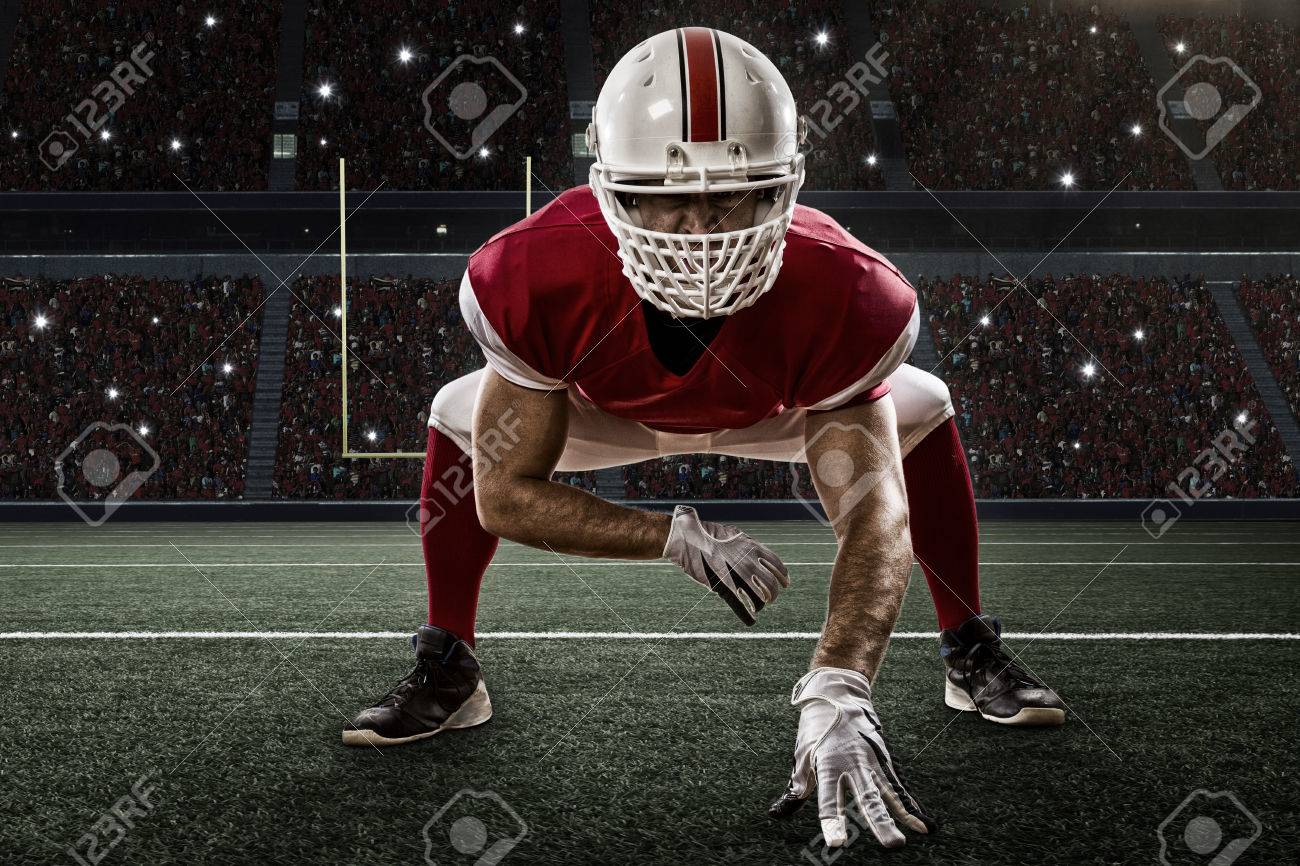 Football Player with a red uniform on the scrimmage line, on a Stadium. - 35219303 Football Player with a red uniform on the scrimmage line, on a Stadium. - 35219303