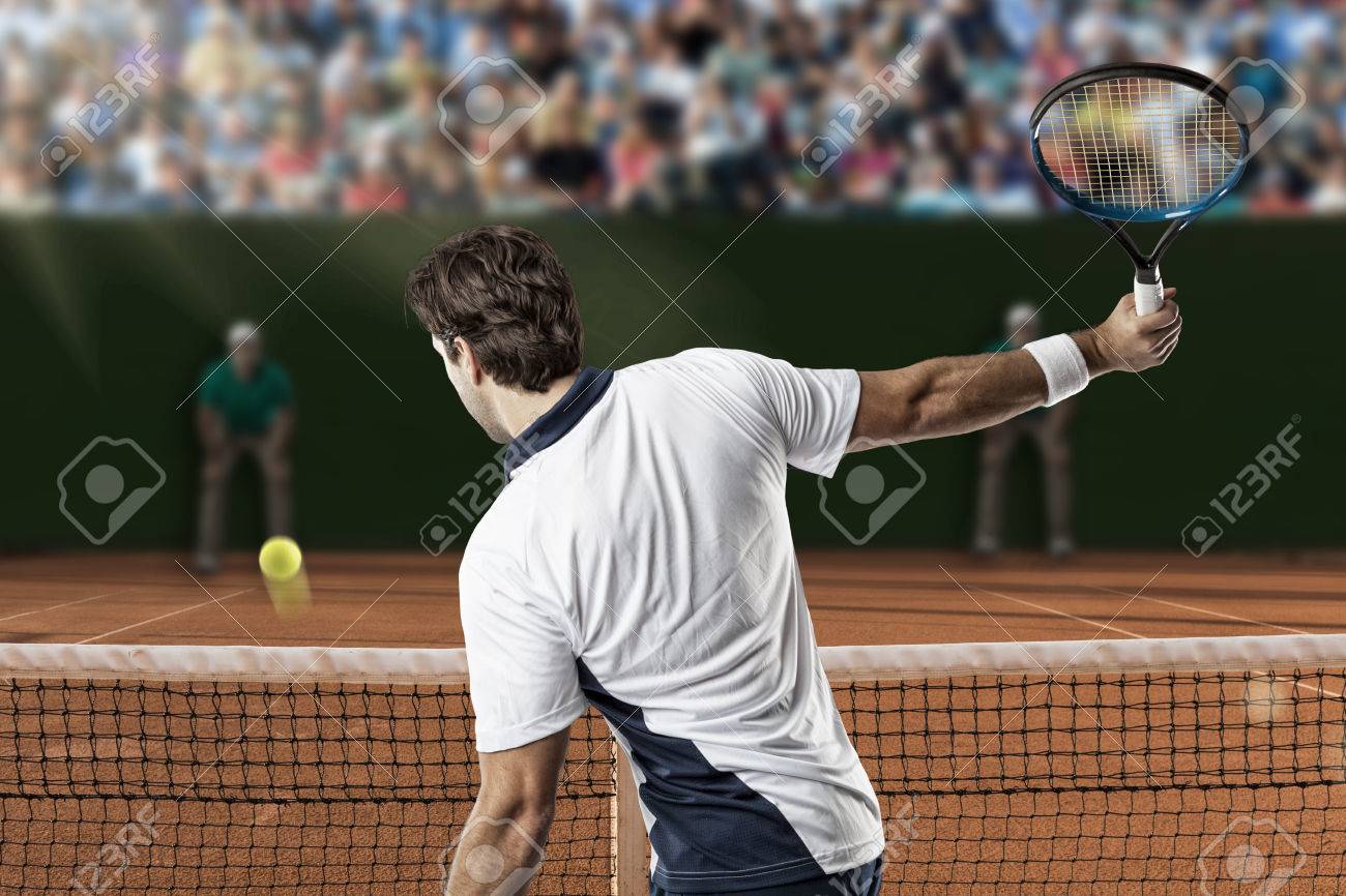 Tennis player returning a ball on a clay tennis court. - 40391808 Tennis player returning a ball on a clay tennis court. - 40391808