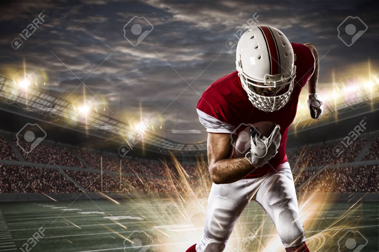Football Player with a red uniform running on a stadium. - 50884860 Football Player with a red uniform running on a stadium. - 50884860