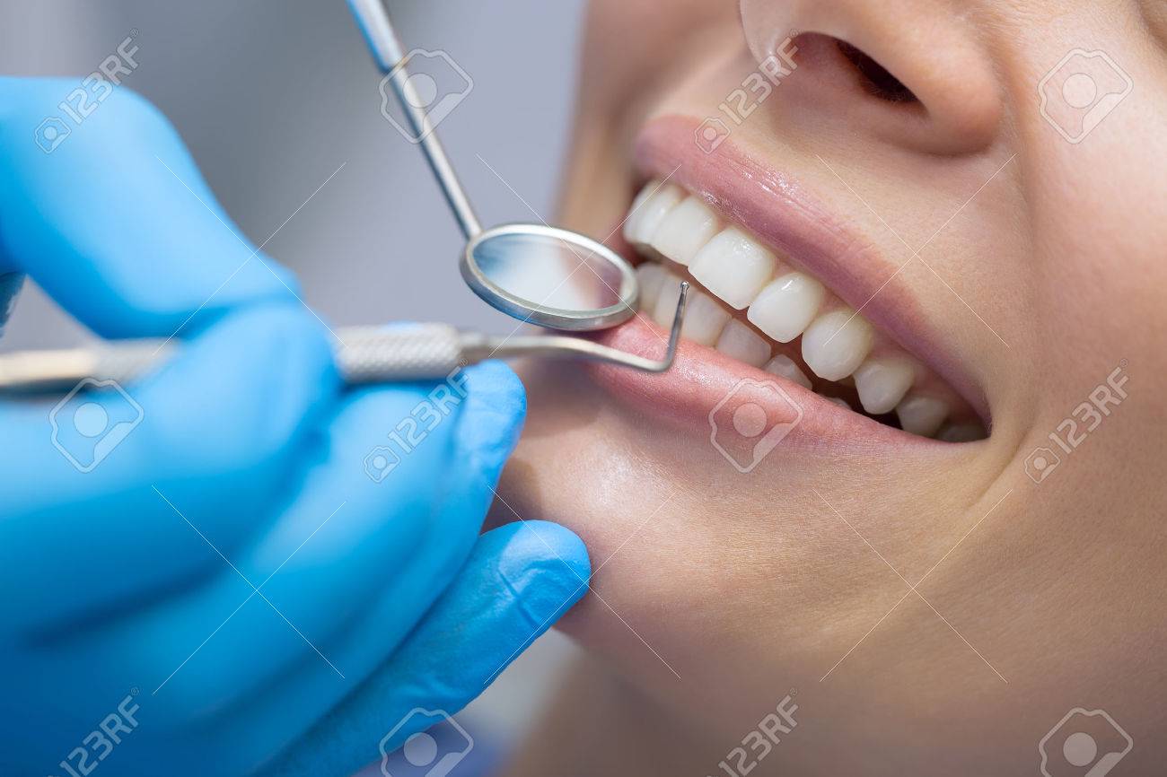 Girl with beautiful white teeth on reception at the doctor dentist. - 51069502 Girl with beautiful white teeth on reception at the doctor dentist. - 51069502