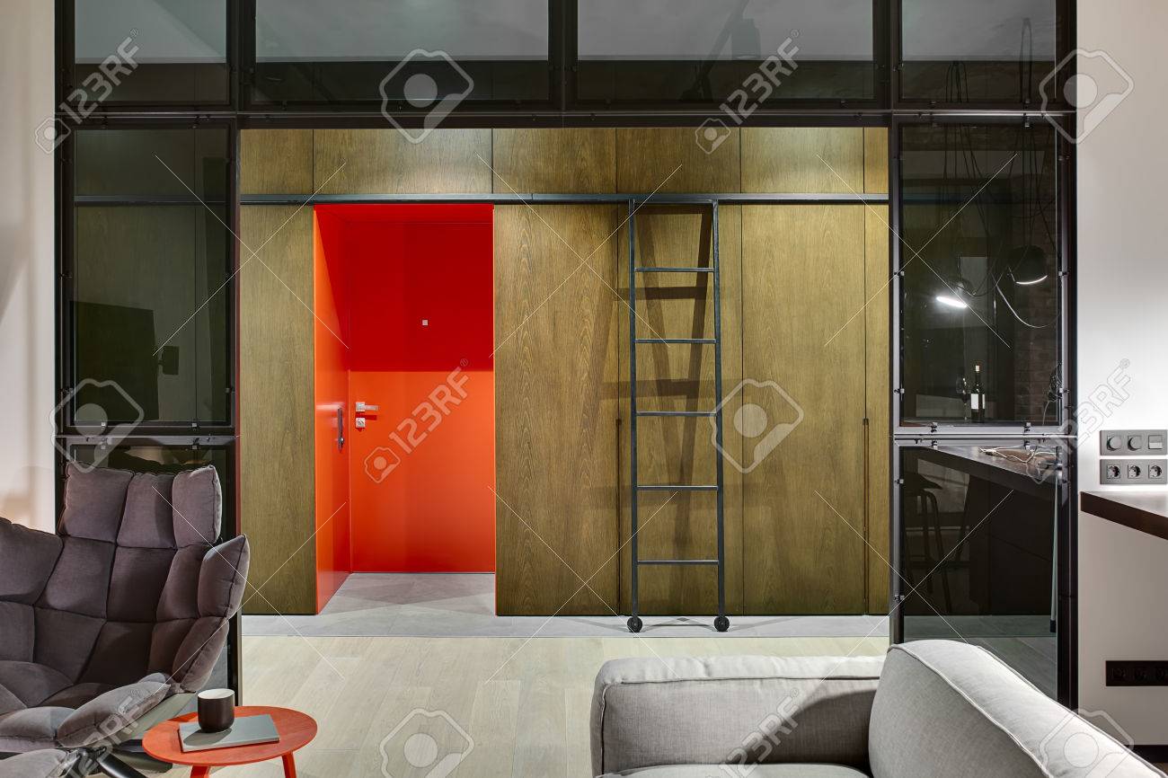 Luminous Hall In A Loft Style With A Red Entrance Door Wooden