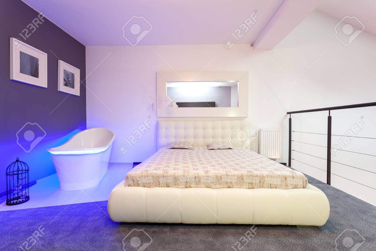 White And Purple Bedroom With Modern Bathtub