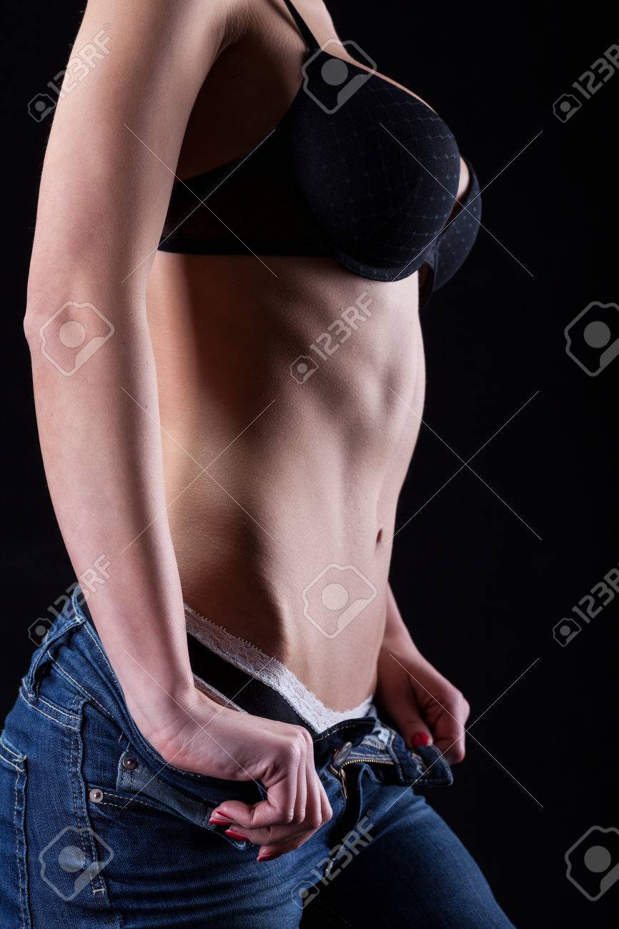 Half-naked Woman Taking Off Her Jeans