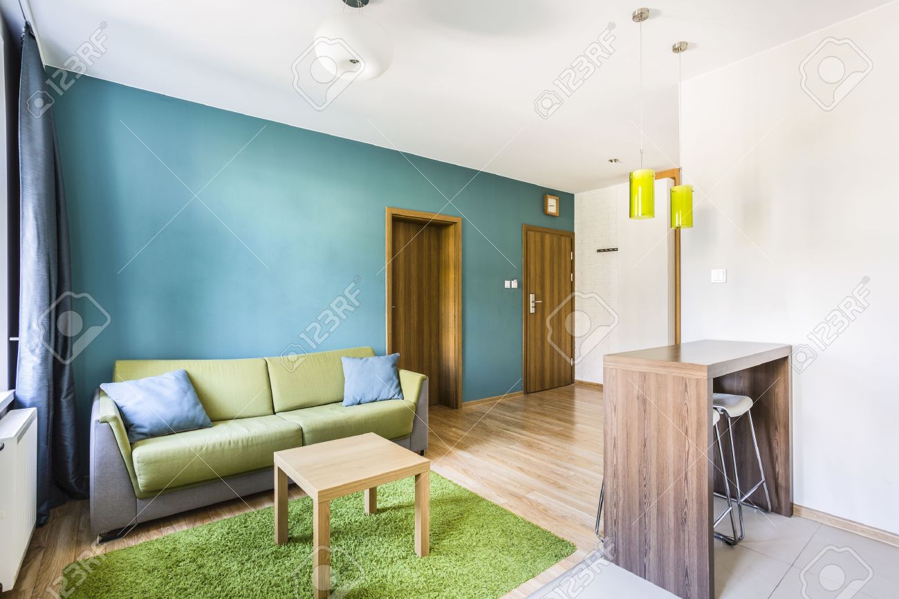 studio apartment interior with cyan wall and green sofa stock studio apartment interior with cyan wall and green sofa stock