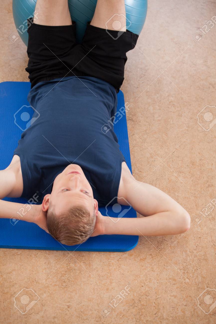 Man Working Out On The Exercise Floor Mat Stock Photo Picture And