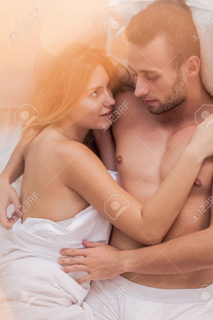 Husband And Wife Lying In Bed