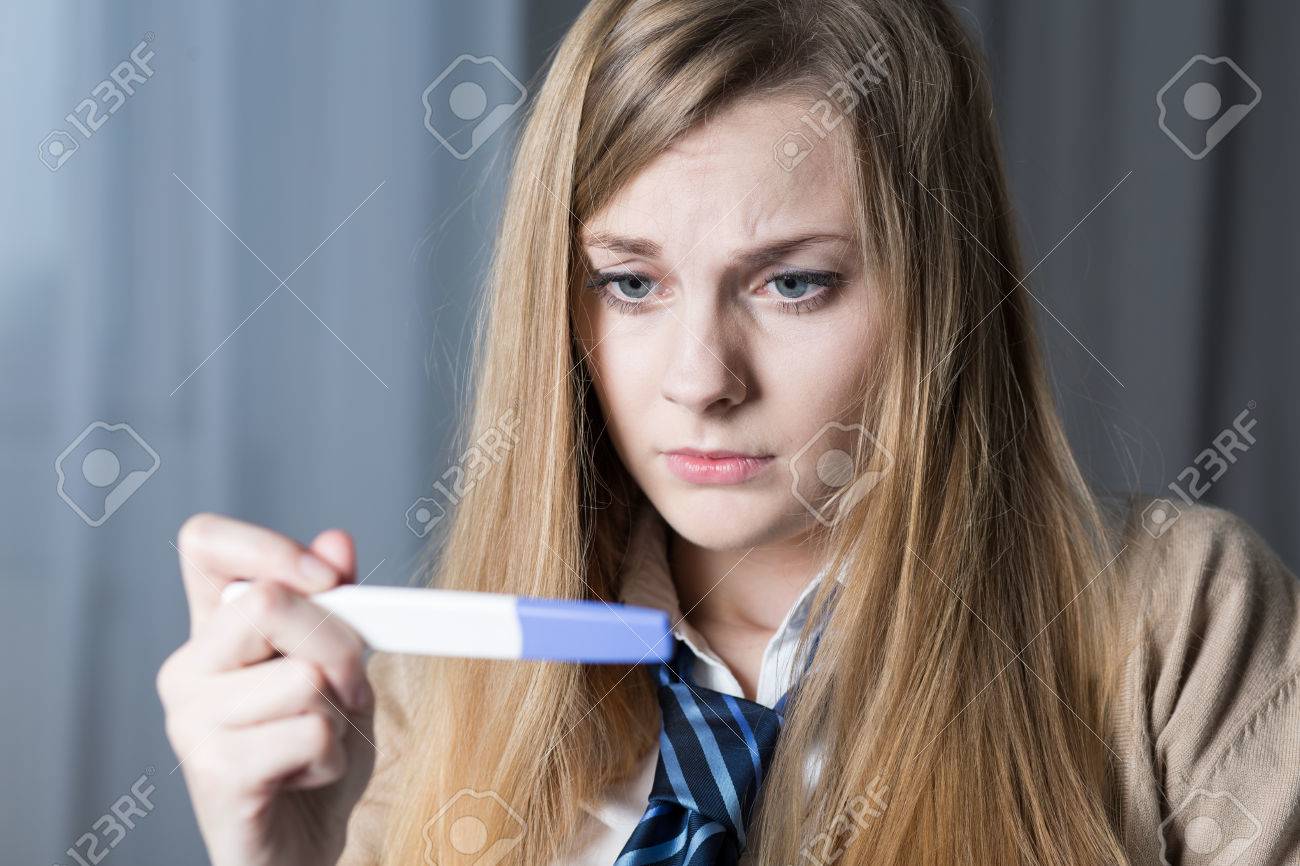 Stressed Teenage Girl Looking On Pregnancy Test Stock Photo, Picture and  Royalty Free Image. Image 51274837.