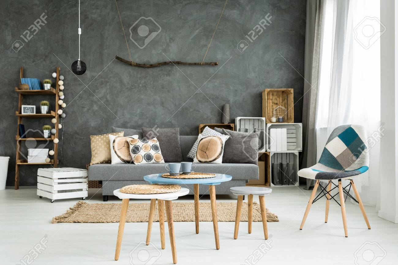 modern minimalistic and bright living room in shades of cyan with sofa full of cushions