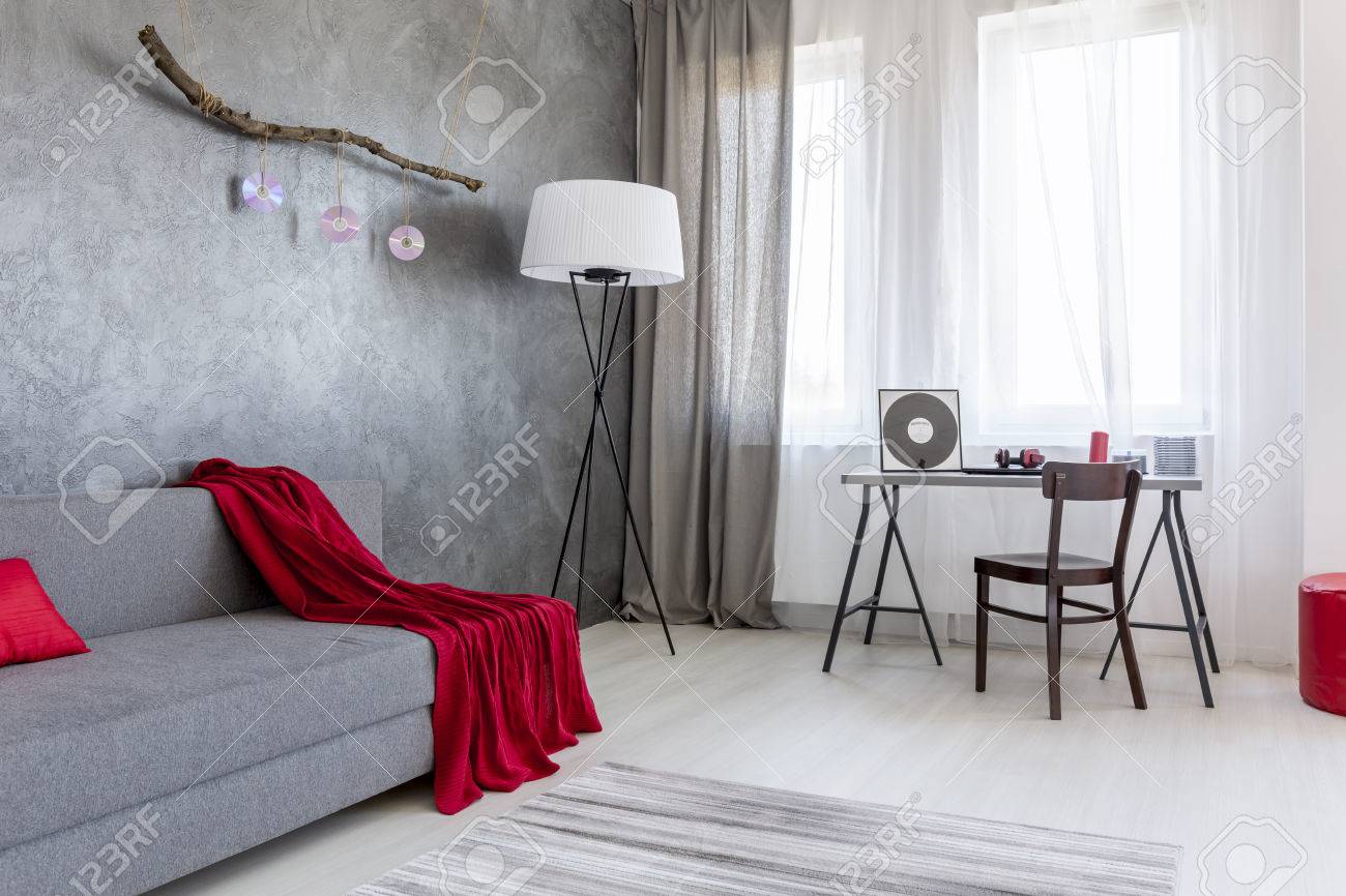 Pleasant Corner Of A Living Room Arranged In Grey With Red Accessories Stock Photo Pleasant Corner Of A Living Room Arranged In Grey With Red Accessories Stock Photo