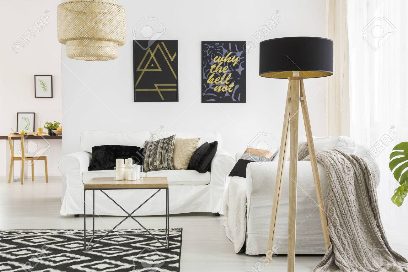 Trendiges Wohnzimmer Mit Weißem Sofa, Schwarzer Lampe Und Tisch ... Trendiges Wohnzimmer Mit Weißem Sofa, Schwarzer Lampe Und Tisch ...